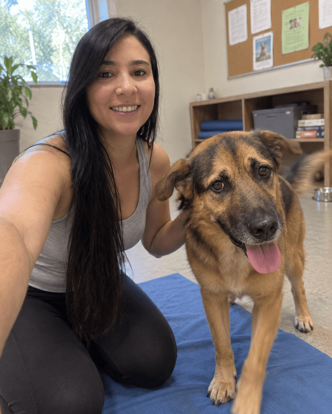 Selfie de una voluntaria con un perro del refugio, los dos mirando a cámara